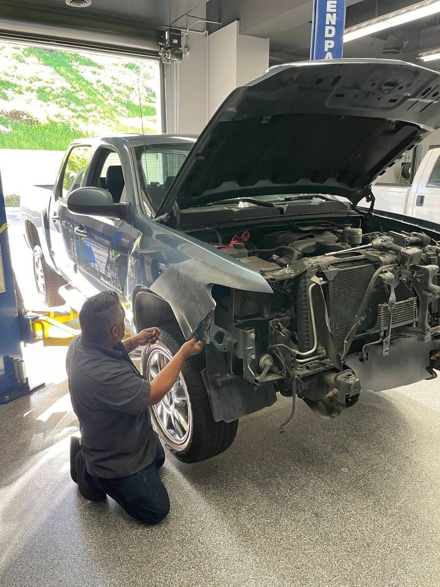 Technician fitting fender components