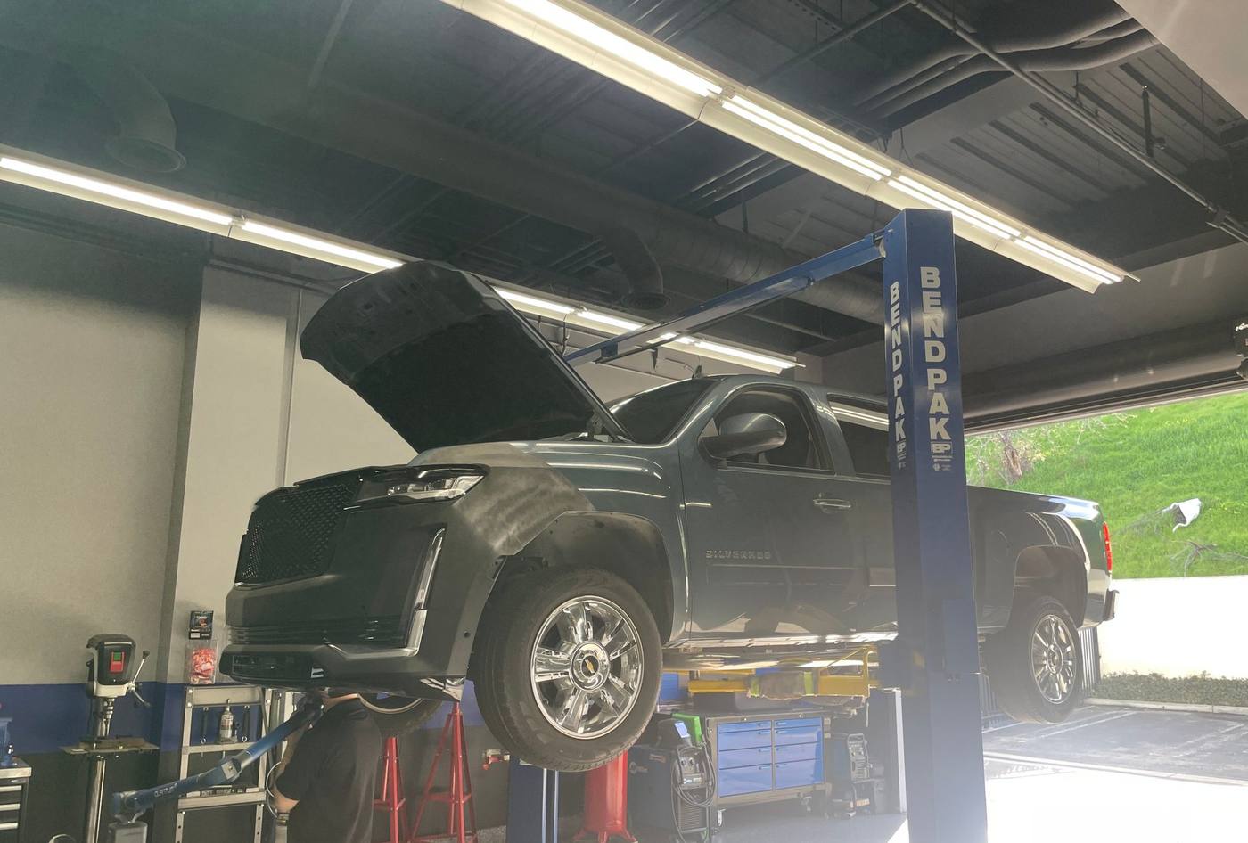 Silverado on the lift during Escalade front-end test fit